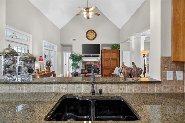 a kitchen with stainless steel appliances granite countertop a refrigerator a stove and a sink with cabinets