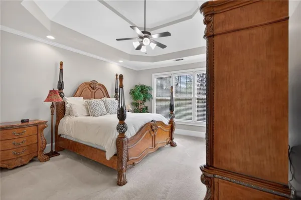 a bedroom with a bed and ceiling fan