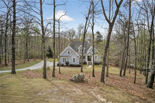 a view of a house with a yard covered in snow