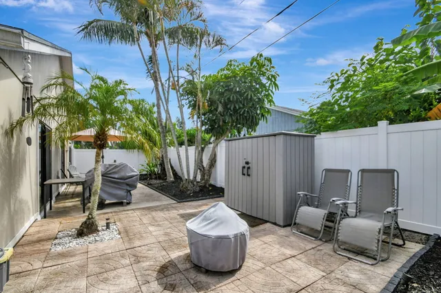 a view of backyard with outdoor seating and plants