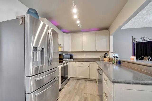 a kitchen with a sink appliances and cabinets