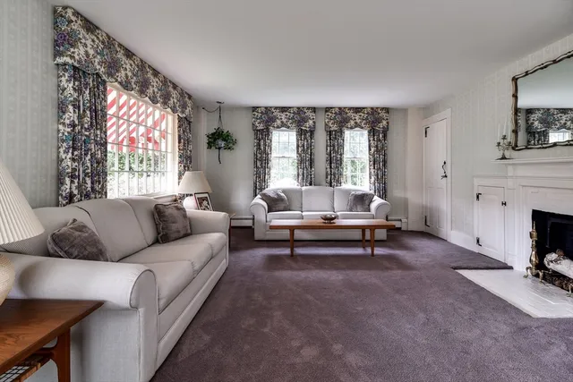 a living room with furniture a rug and a chandelier