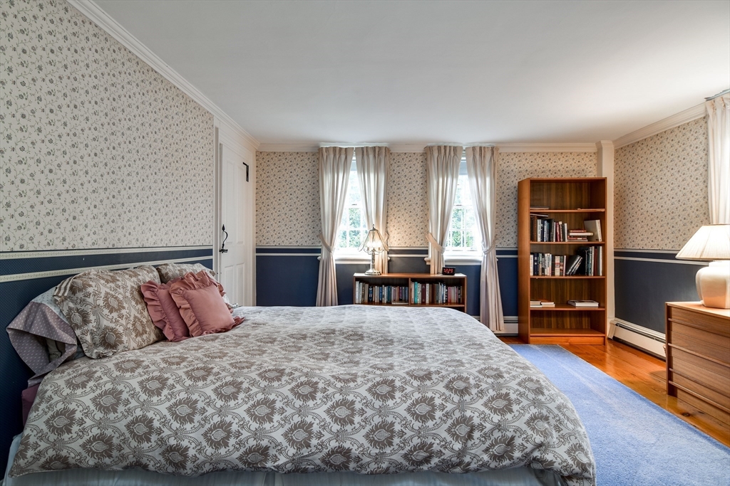 192 West Main Street Westborough, MA 01581 - Photo 19 of 42 a bedroom with a large bed and a tv