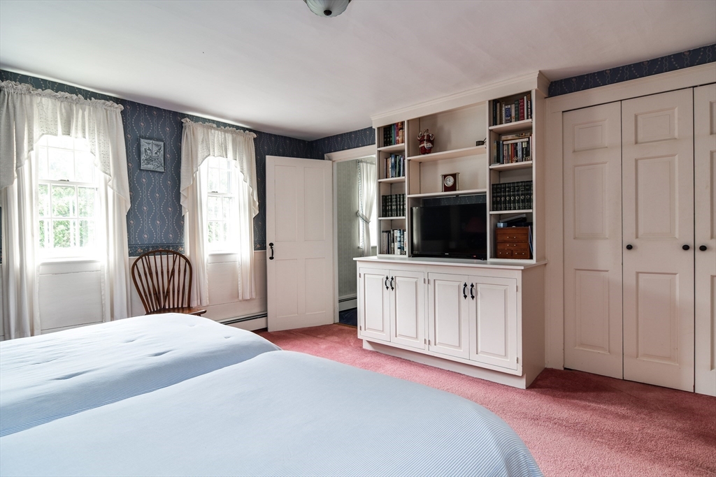 192 West Main Street Westborough, MA 01581 - Photo 20 of 42 a bedroom with a bed and a flat screen tv