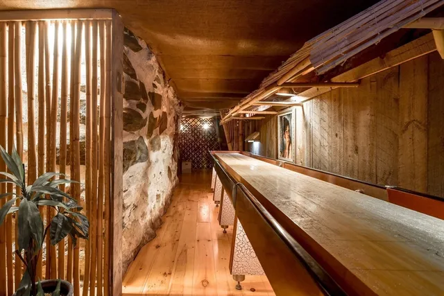 a front view of a house with a yard and a garden