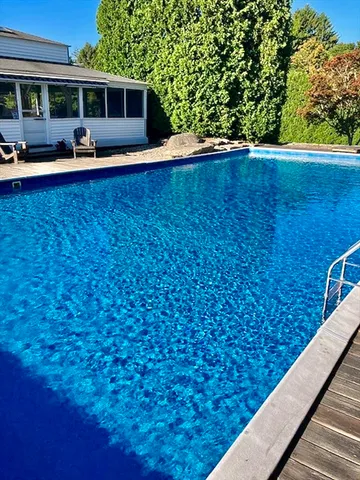a view of a field with large trees