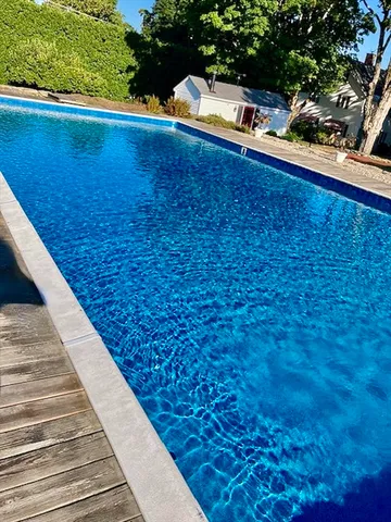 a front view of a house with a tree