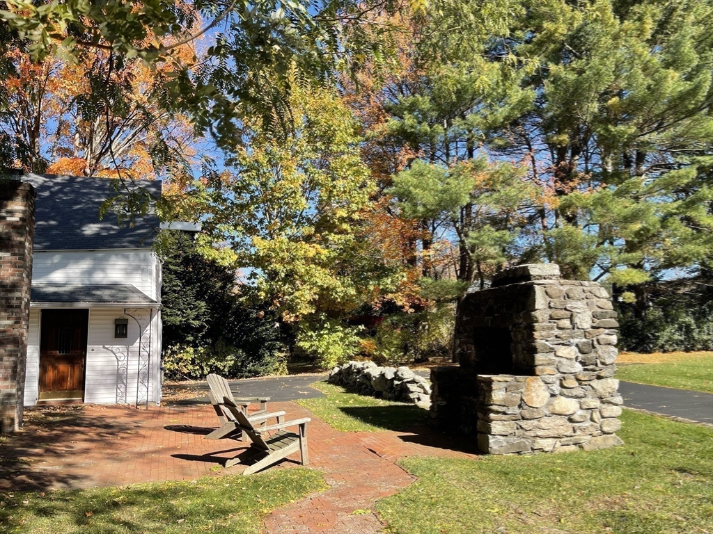 192 West Main Street Westborough, MA 01581 - Photo 38 of 42 a view of a swimming pool with a bench and trees around