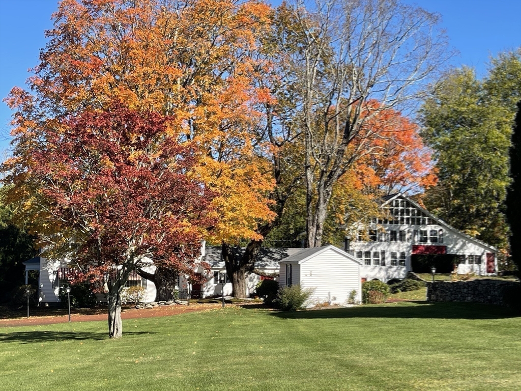 192 West Main Street Westborough, MA 01581 - Photo 39 of 42 a view of a white house with a yard and sitting area