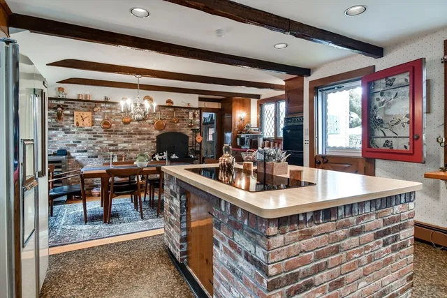 a living room with fireplace a rug and a table