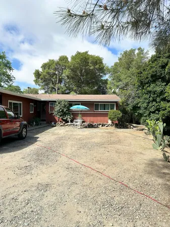a view of house with outdoor space and car parked