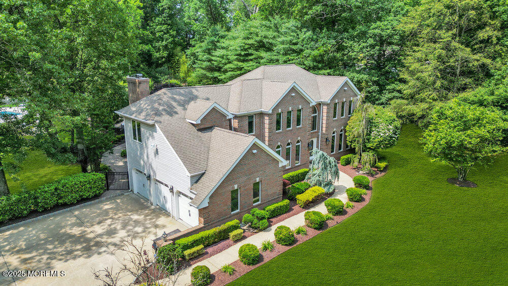 203 Stone Hill Road Freehold, NJ 07728 - Photo 2 of 83 a aerial view of a house with a big yard plants and large trees