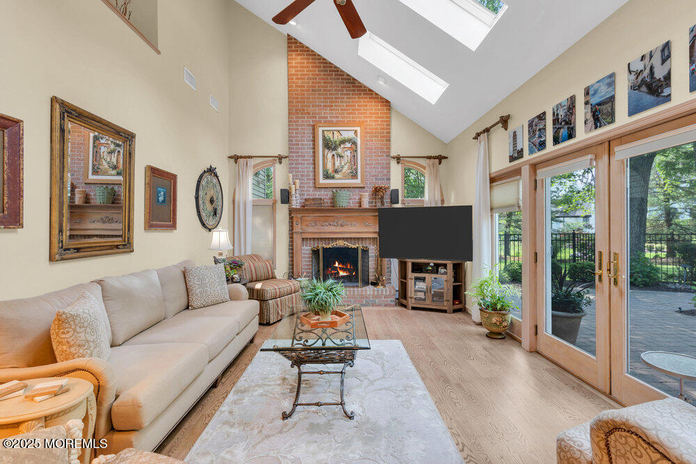 203 Stone Hill Road Freehold, NJ 07728 - Photo 26 of 83 a living room with furniture a large window and a fireplace