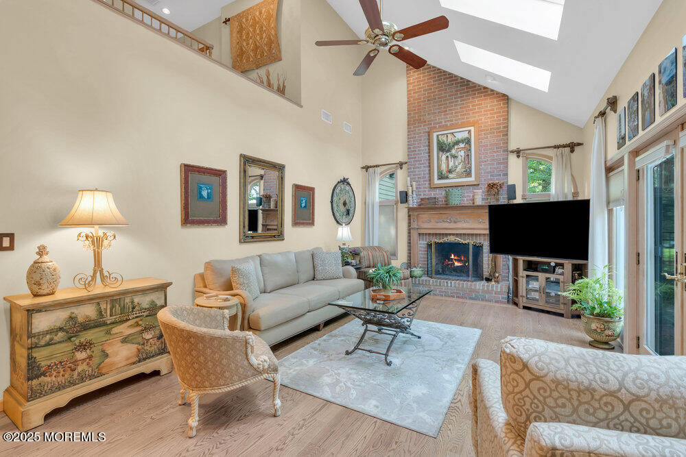 203 Stone Hill Road Freehold, NJ 07728 - Photo 27 of 83 a living room with furniture a flat screen tv and a fireplace