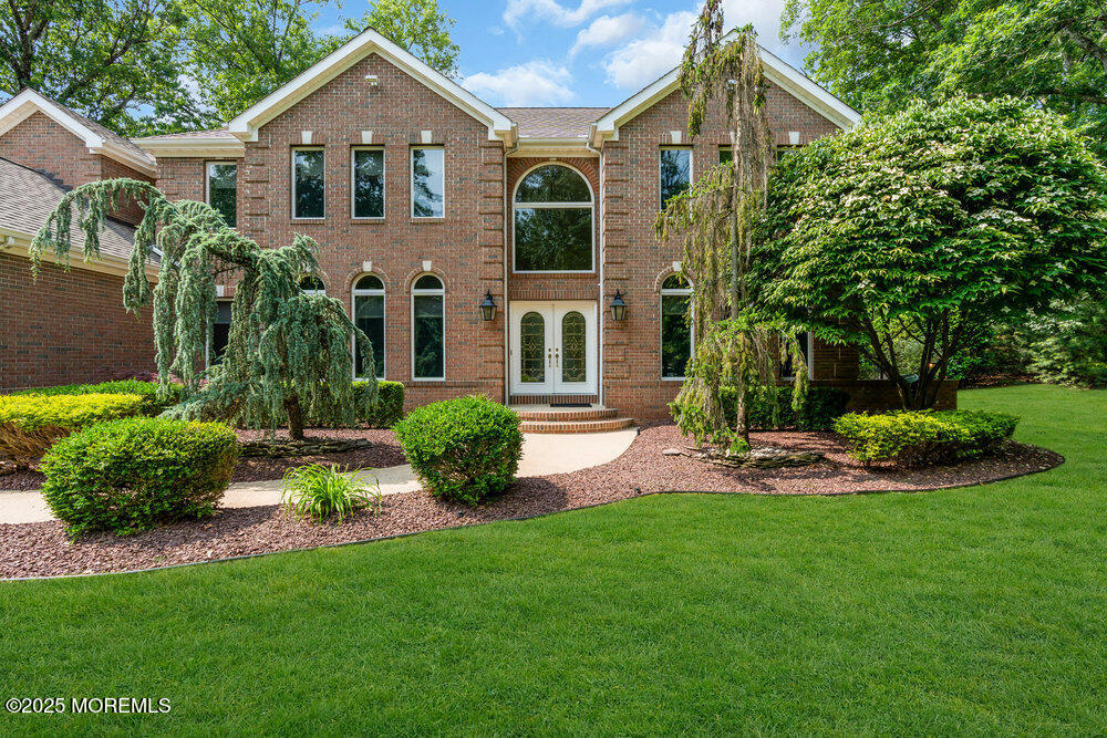203 Stone Hill Road Freehold, NJ 07728 - Photo 3 of 83 a front view of a house with a yard and green space