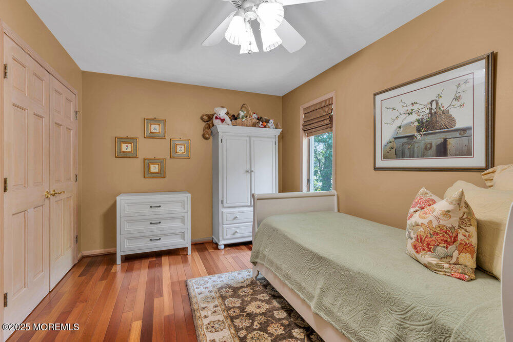 203 Stone Hill Road Freehold, NJ 07728 - Photo 42 of 83 a bedroom with a bed and a chandelier