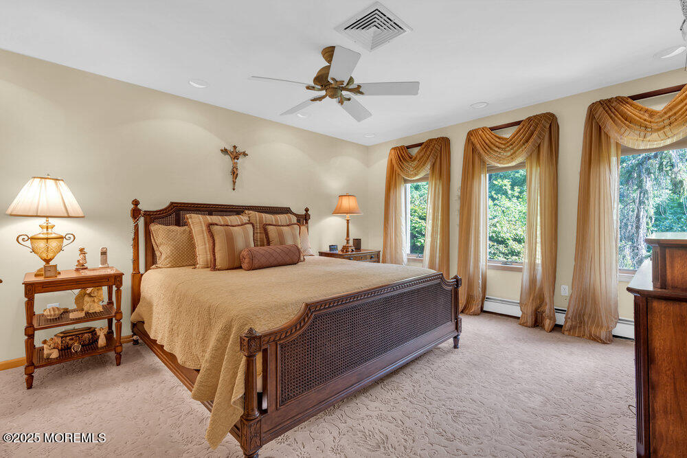 203 Stone Hill Road Freehold, NJ 07728 - Photo 45 of 83 a bedroom with a bed and a chandelier
