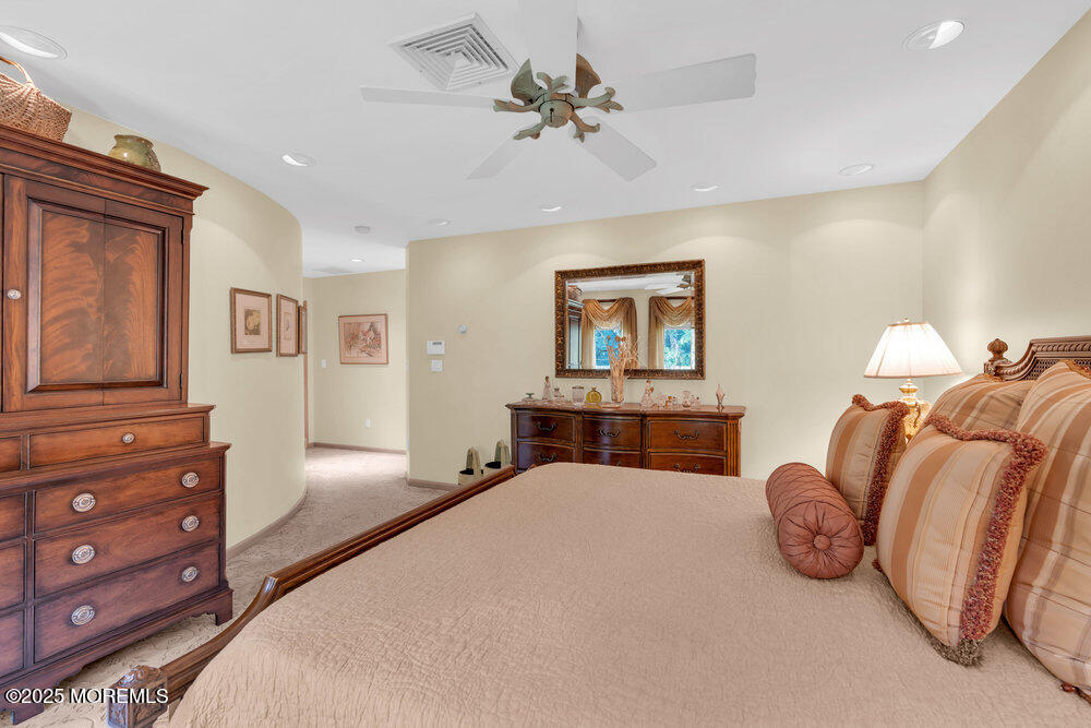 203 Stone Hill Road Freehold, NJ 07728 - Photo 46 of 83 a bedroom with a bed and a chandelier