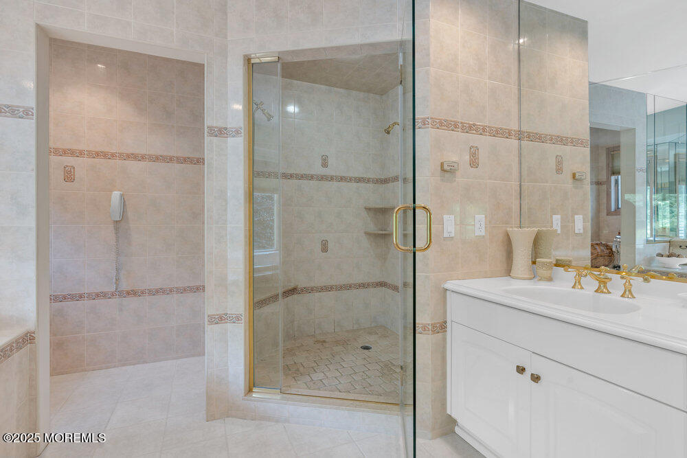 203 Stone Hill Road Freehold, NJ 07728 - Photo 49 of 83 a bathroom with a shower sink and mirror
