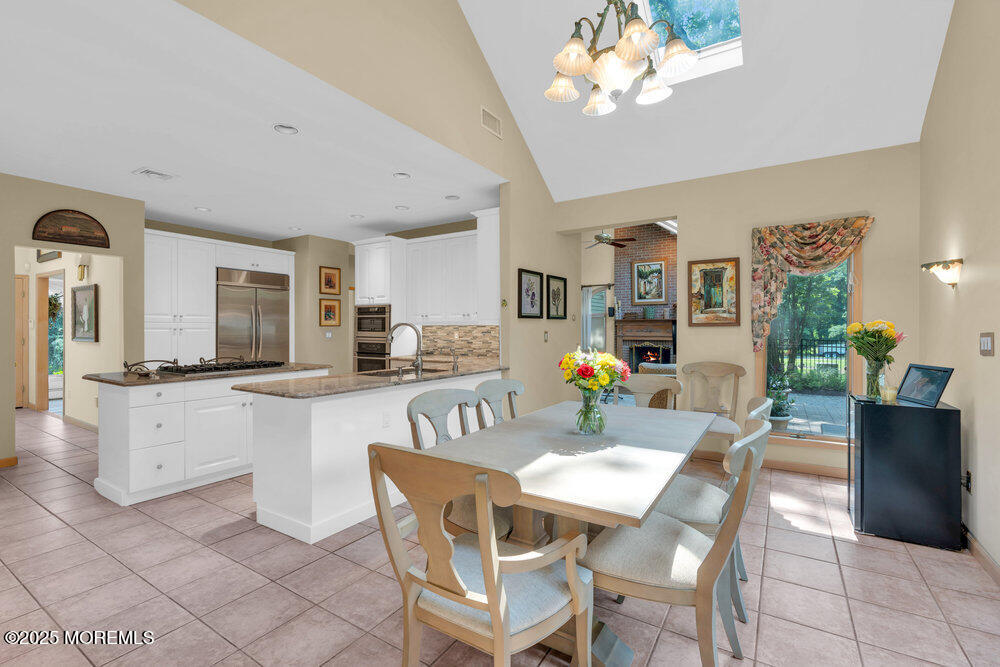 203 Stone Hill Road Freehold, NJ 07728 - Photo 5 of 83 a kitchen with stainless steel appliances kitchen island granite countertop a sink and cabinets