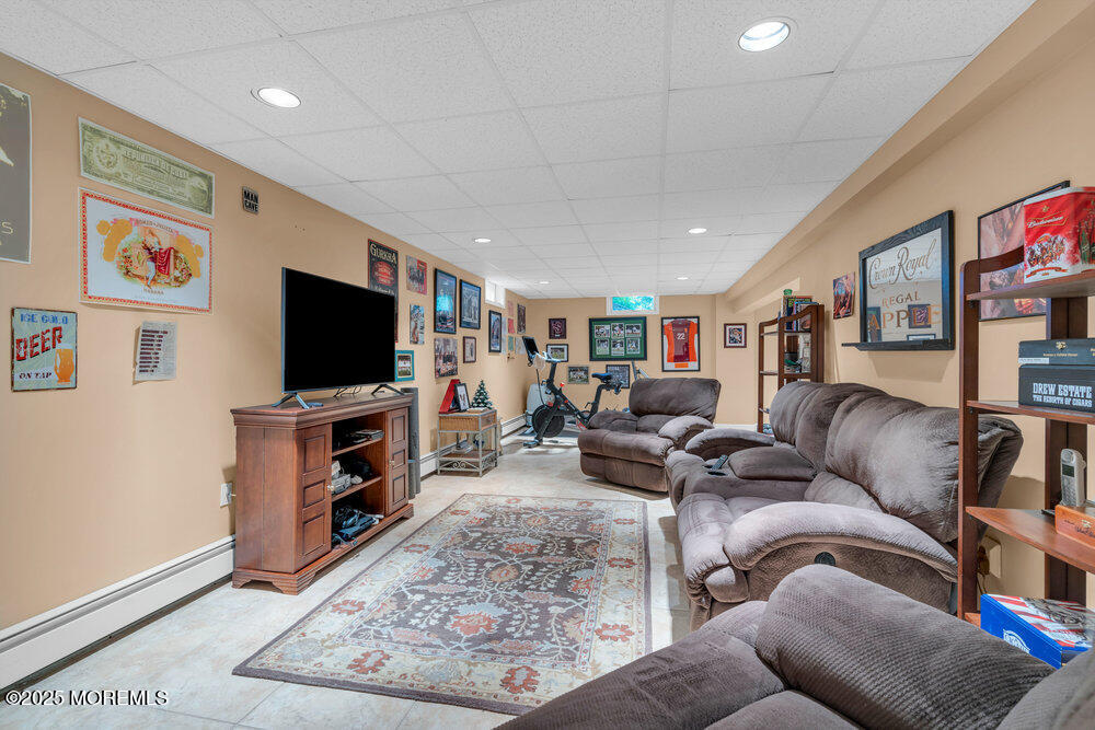 203 Stone Hill Road Freehold, NJ 07728 - Photo 54 of 83 a living room with furniture and a flat screen tv