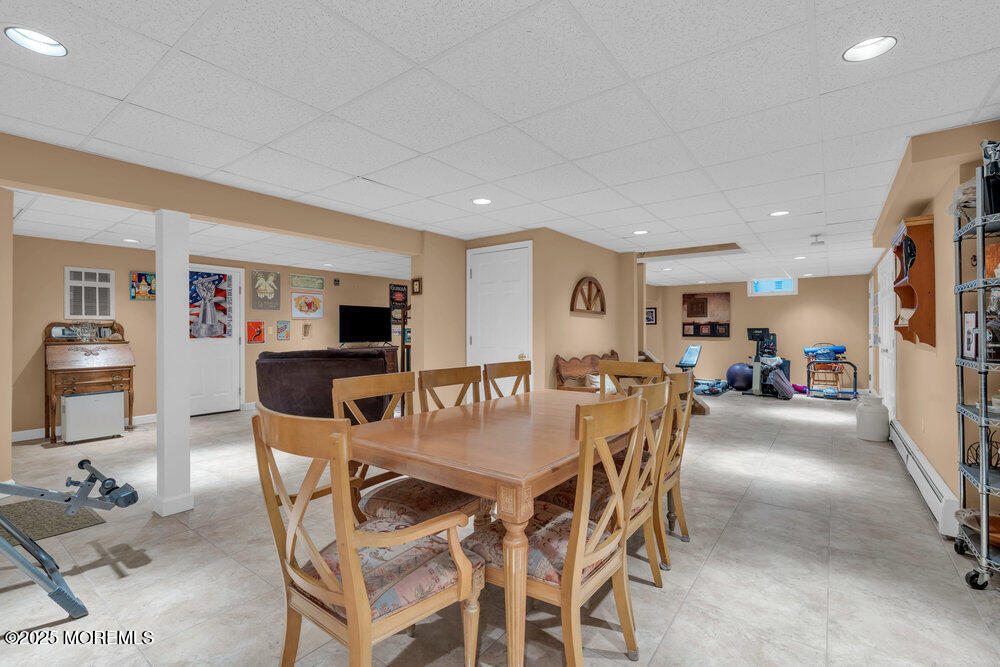 203 Stone Hill Road Freehold, NJ 07728 - Photo 55 of 83 a dining room with furniture and a kitchen view