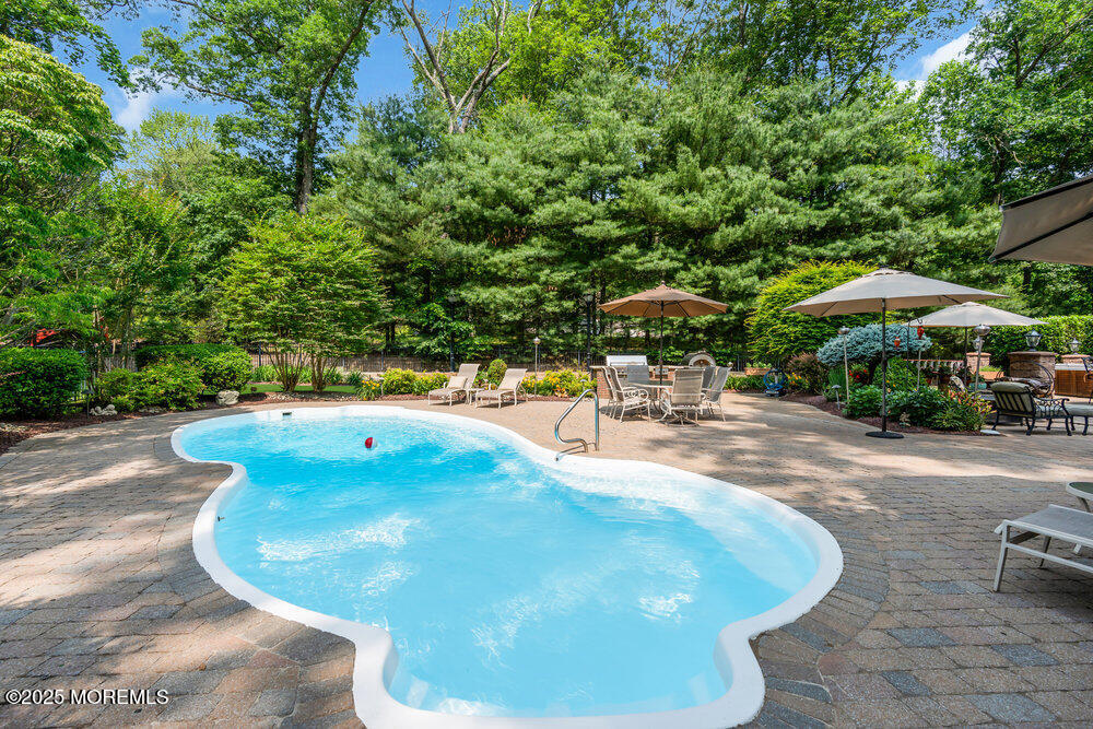 203 Stone Hill Road Freehold, NJ 07728 - Photo 72 of 83 a view of a swimming pool with an outdoor space and sitting area