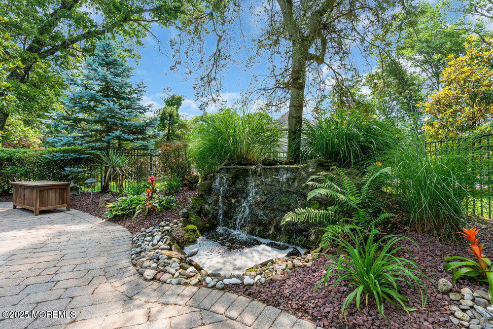 203 Stone Hill Road Freehold, NJ 07728 - Photo 73 of 83 a view of a backyard with plants and large trees