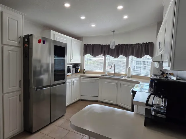 a view of a dining room with furniture wooden floor and chandelier