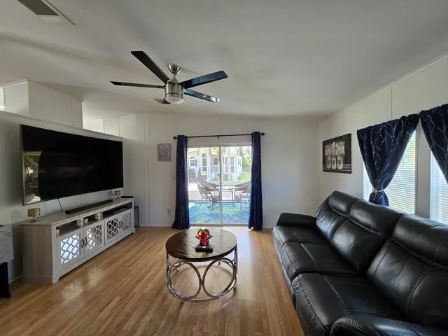 a living room with furniture and a floor to ceiling window