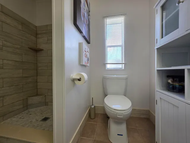 a bedroom with a bed and a flat tv screen on dresser