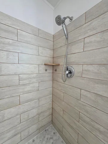 a bedroom with a bed and a mirror on dresser