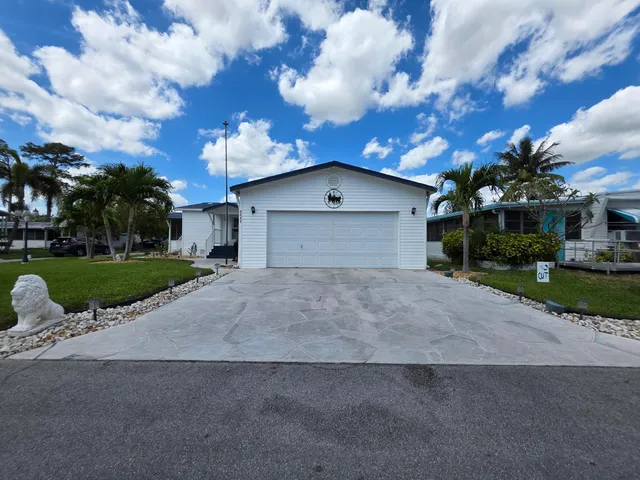 a view of a house with a yard and garage