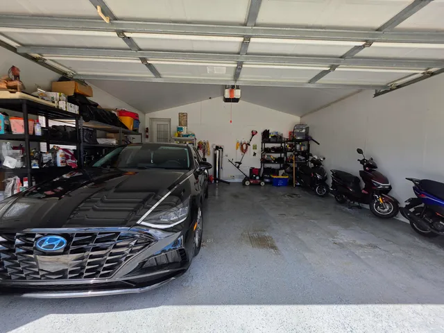 a kitchen with granite countertop a refrigerator and a sink