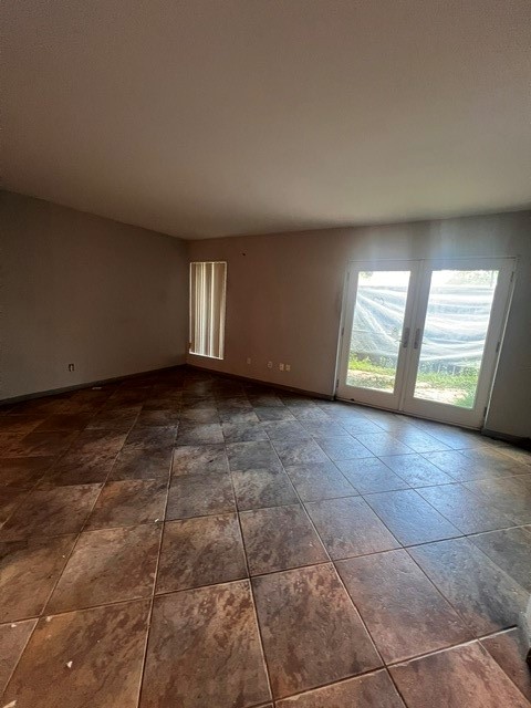 6304 South Rice Avenue Bellaire, TX 77401 - Photo 7 of 16 a view of an empty room with a fireplace and a window