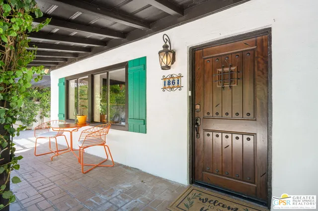 a view of a porch with a table and chairs and potted plants