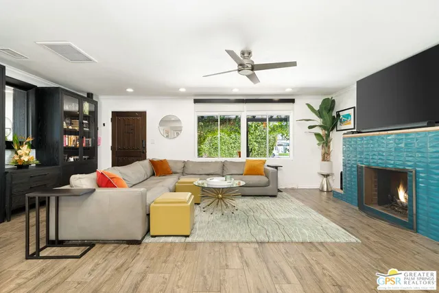a living room with furniture and a fireplace