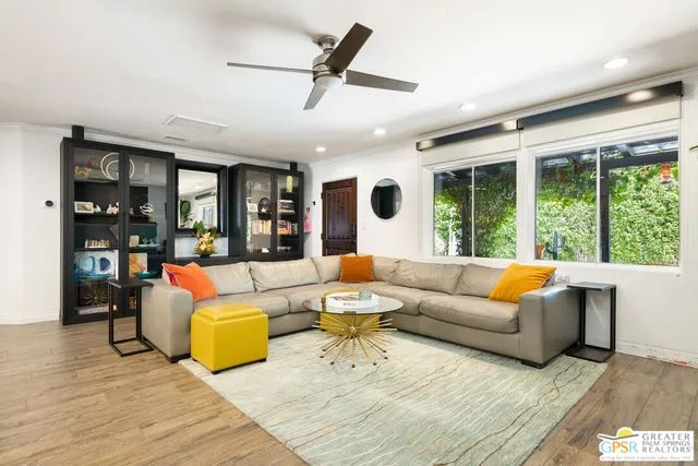 a living room with furniture and large windows