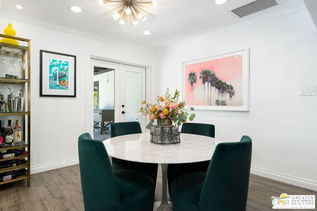 a dining room with furniture and wooden floor