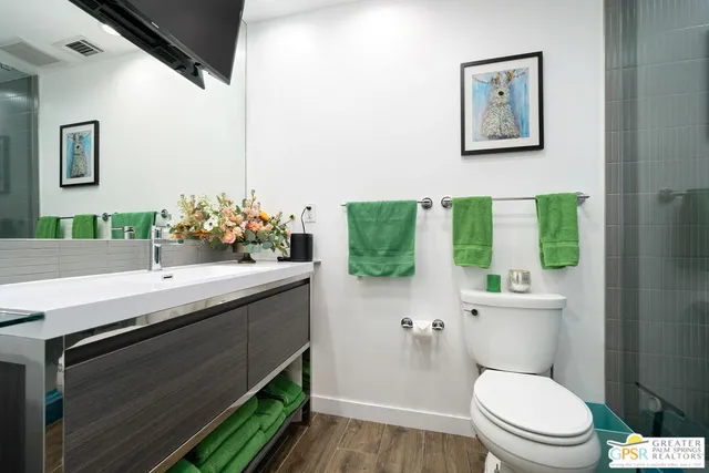 a bathroom with a sink mirror vanity and toilet