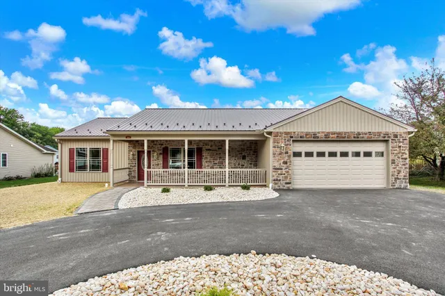 a front view of a house with a garden and yard