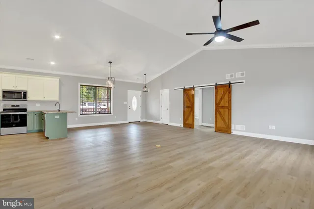 a view of an empty room with window and fireplace