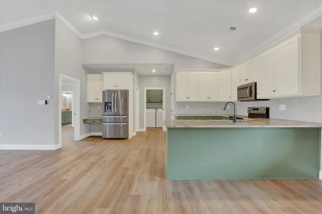 a kitchen with granite countertop a stove top oven sink and cabinets