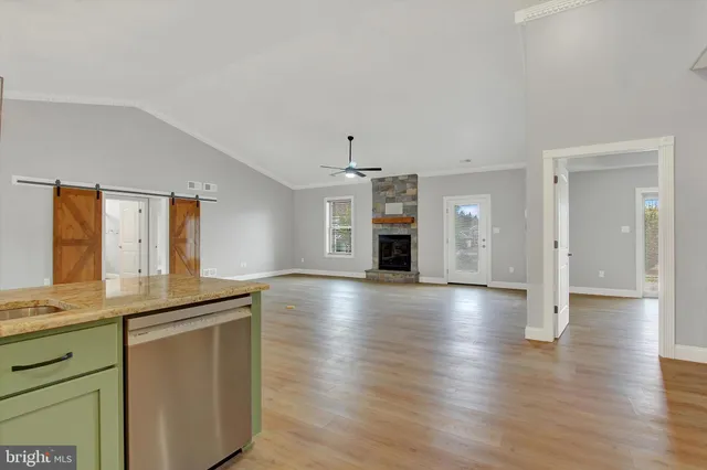 a kitchen with granite countertop white cabinets and stainless steel appliances
