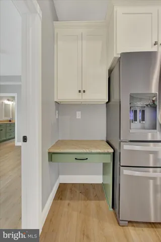 a view of kitchen with livingroom and wooden floor