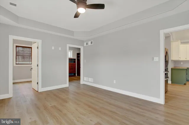 wooden floor in an empty room with a window