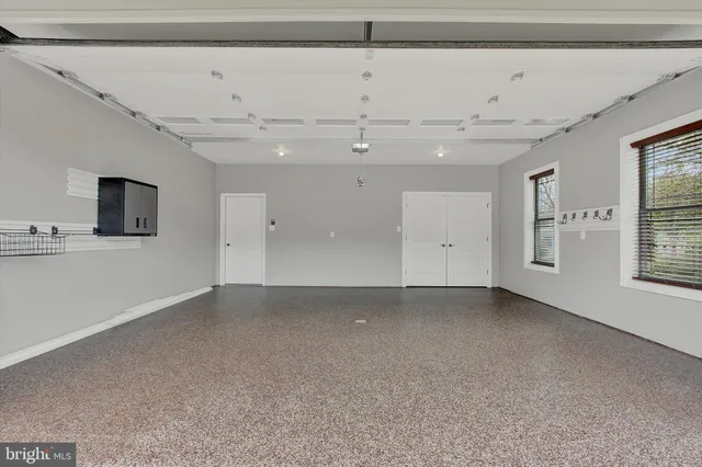 a bathroom with a granite countertop sink mirror and toilet