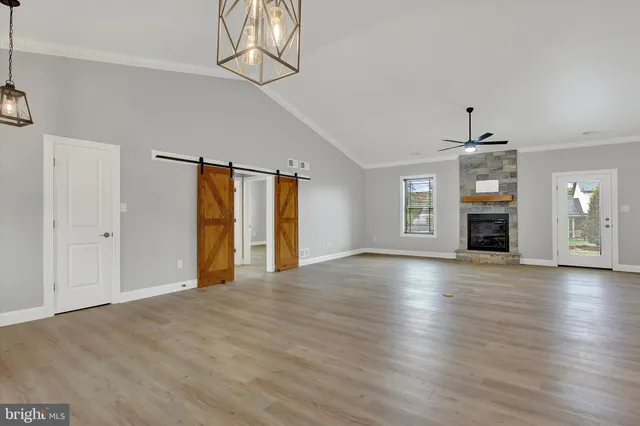 a living room with a fireplace and a wooden floor