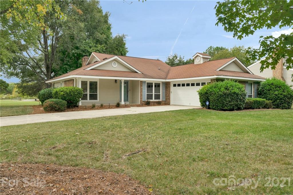 9838 Fairway Ridge Road, Unit 11 Charlotte, NC 28277 - Photo 2 of 40 a front view of a house with a garden