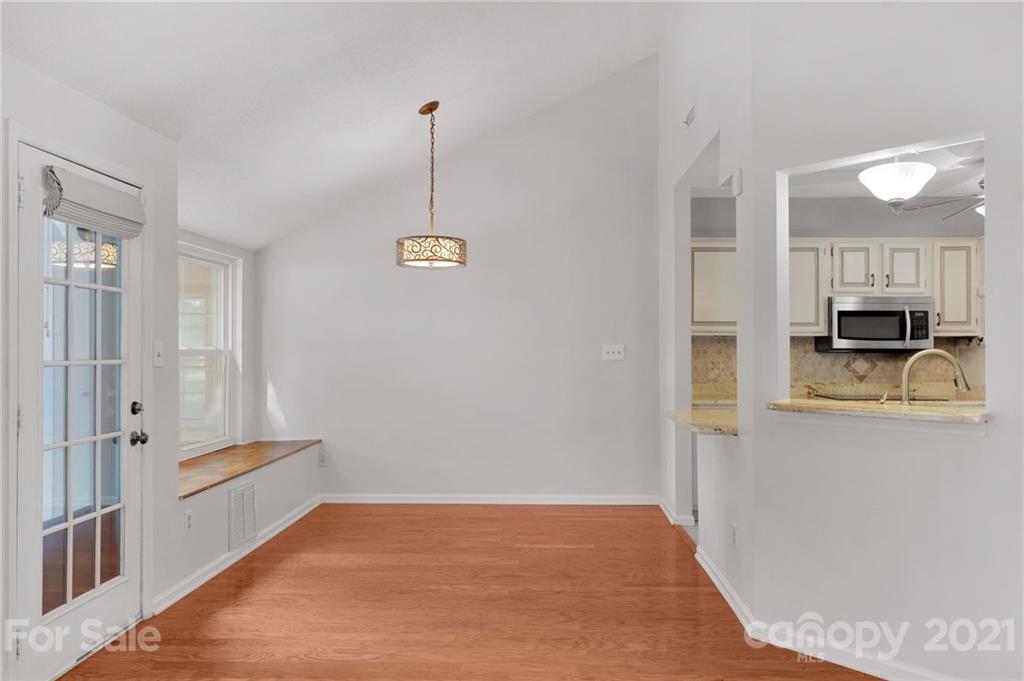 9838 Fairway Ridge Road, Unit 11 Charlotte, NC 28277 - Photo 11 of 40 a view of a kitchen with wooden floor and electronic appliances
